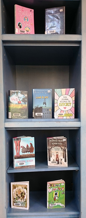 Bookshelf filled with books that depict homeschooled children