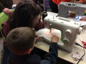 A child learning basic machine sewing