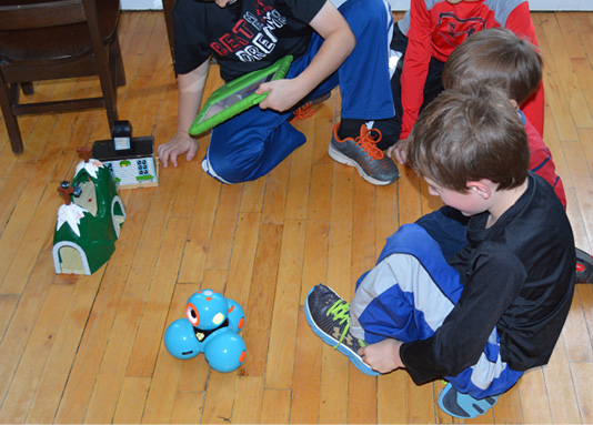 students playing with a Dash robot