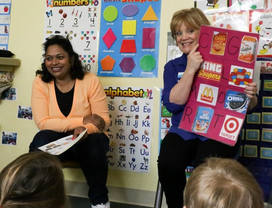 Laurie Anne and a classroom teacher collaborate during storytime.