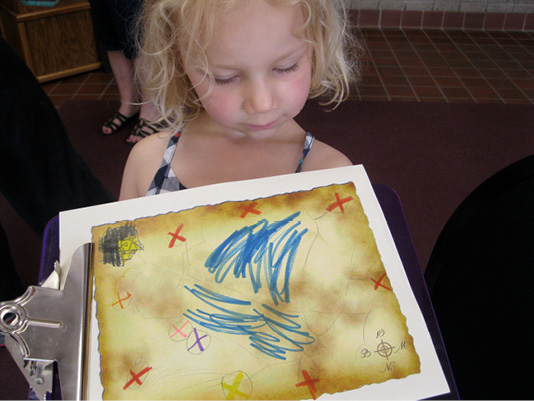 A girl holding a hand-drawn map