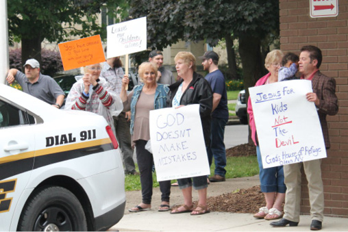 Protesters rallied outside the Olean Public Library to make their voices heard about drag queen storytimes.