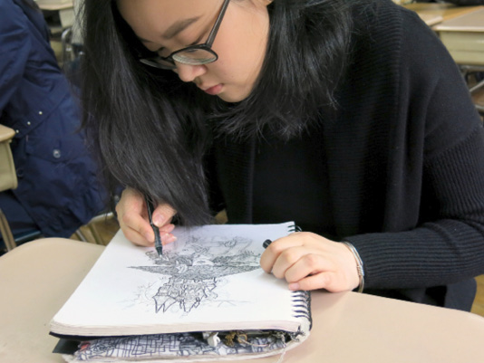 Grades 9–12: Annie perfects her illustrations.