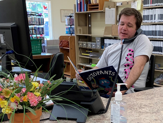 Joel Shoemaker, librarian at Illinois Prairie District Public Library, reads a story via phone during the pandemic as part of its Dial a Story program. With a dedicated phone number, a new story every Monday, and daily statistics, the program saw as many as twenty people call daily to this rural branch in Metamora, IL. 