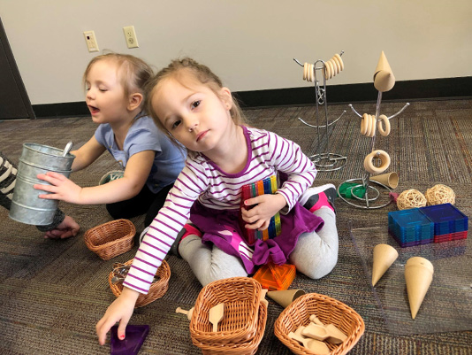 These sisters love using all the random loose parts to create their own inventive play.