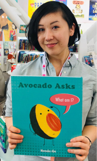 Momoko Abe holding a copy of Avocado Asks