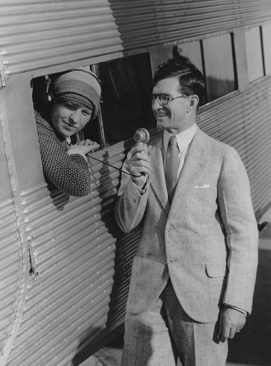 1930 Newbery winner Rachel Field and ALA President Milton J. Ferguson reenact their mid-air radio communication after landing.