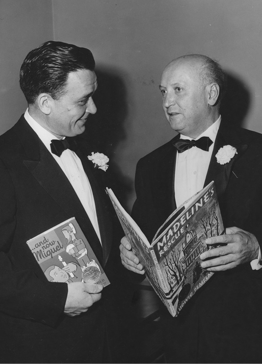Newbery winner Joseph Krumgold chats with Caldecott winner Ludwig Bemelmans at the 1954 Banquet.