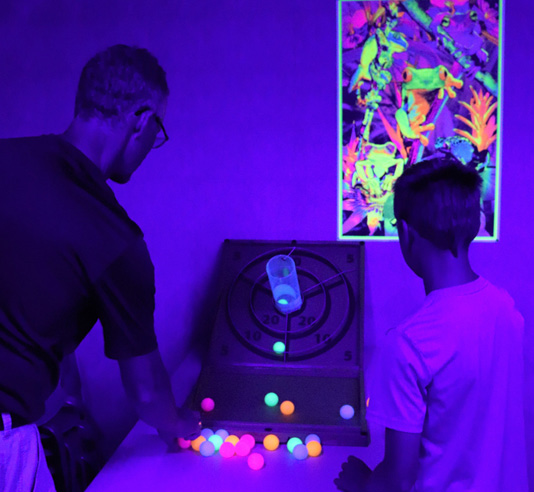 A skee-ball game using blacklight ping-pong balls was a huge hit, as were blacklight posters decorating the room. 