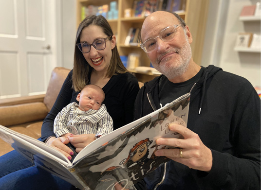 Stephanie Bange and her husband reading to their daughter.