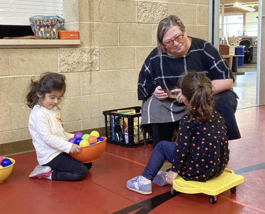 Madison (WI) Public Librarian Carissa Christner actively observes and listens to participants at Anji Playdate, an open-ended true play program.