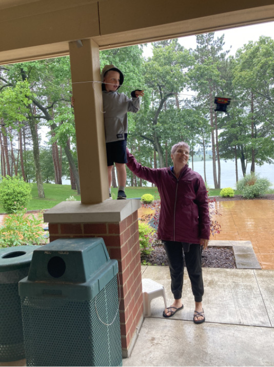 A child and caregiver test and retest this LEGO zipline at the Waupaca (WI) Public Library program in the park.