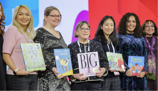 Members of the Caldecott committee show off the newly minted 2024 medal and honor books.