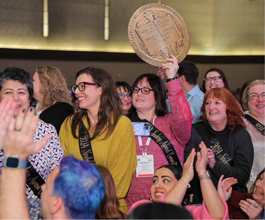 Newbery committee members stand to be recognized during the press conference.