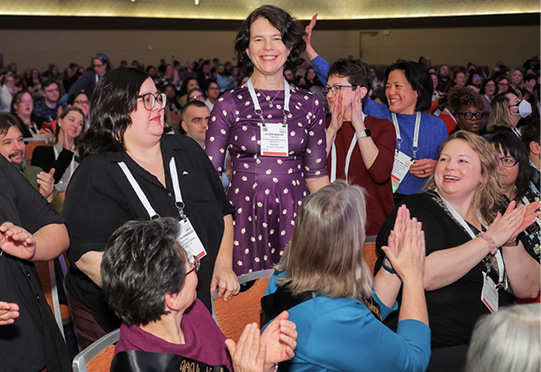 Members of the Pura Belpré committee are recognized by colleagues during the press conference.