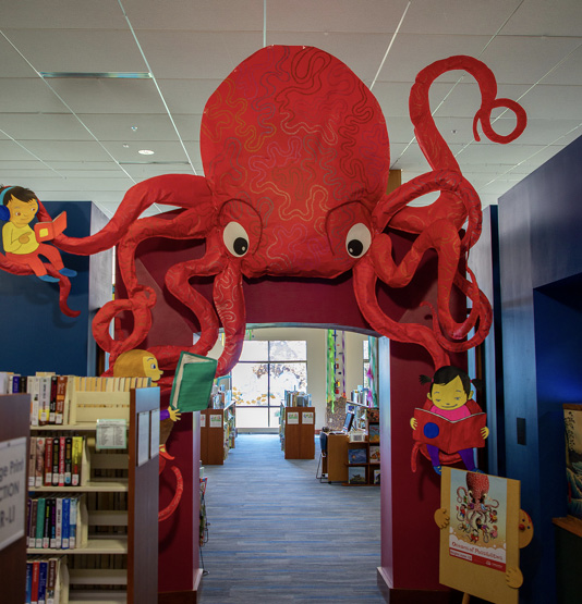 Children's library entrance with a large pink octopus above the entrance