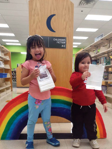 The end of the rainbow is in the children’s area of the Martin Regional Library in Tulsa! These sisters enjoyed attending a 2024 National Take Your Child to the Library Day event. Photo courtesy of Laura Raphael.
