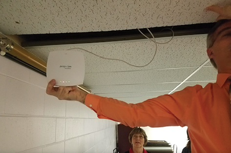 Tom Rolfes (education information technology manager at Nebraska Information Technology Commission) finds a hidden Wi-Fi access point during a site visit to a Nebraska library.