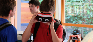 Figure 2. A teenager tests inexpensive virtual reality goggles that anyone with a smartphone can use